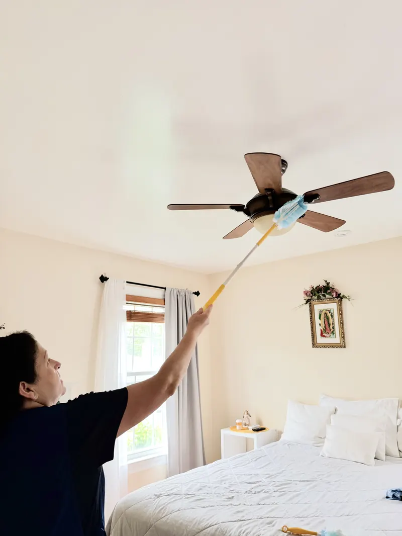 Lore dusting a ceiling fan